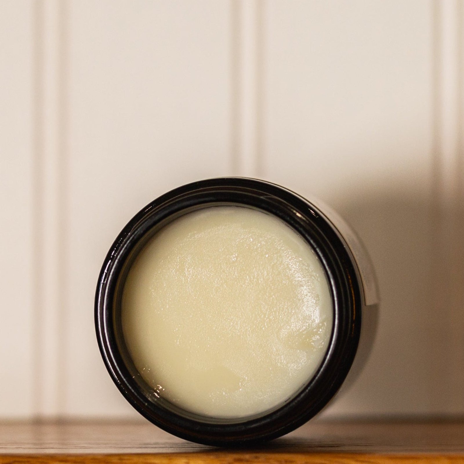 Open jar of HydroTallow tallow balm with a smooth, melty surface