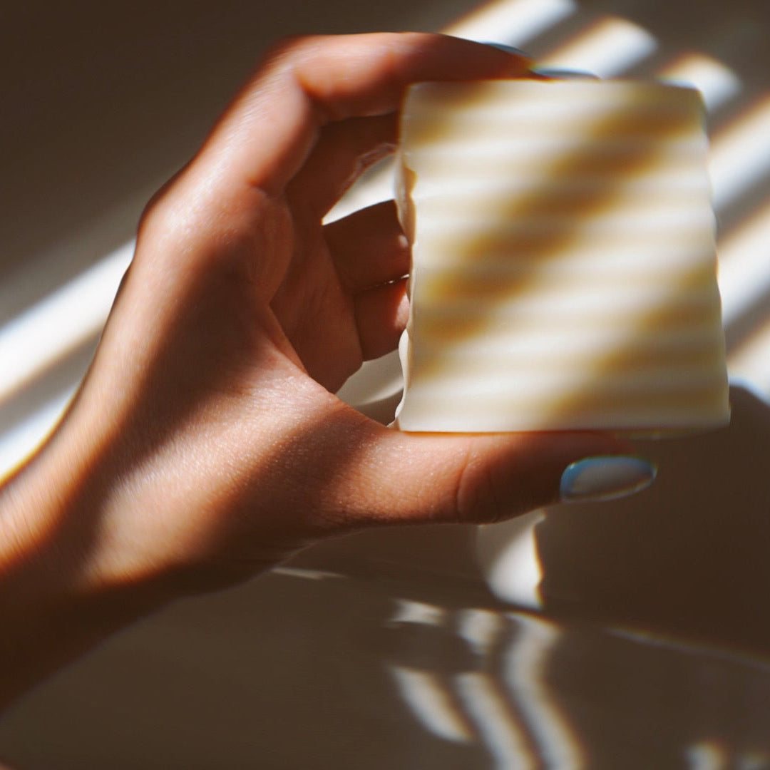 Hand holding a HydroTallow tallow soap bar